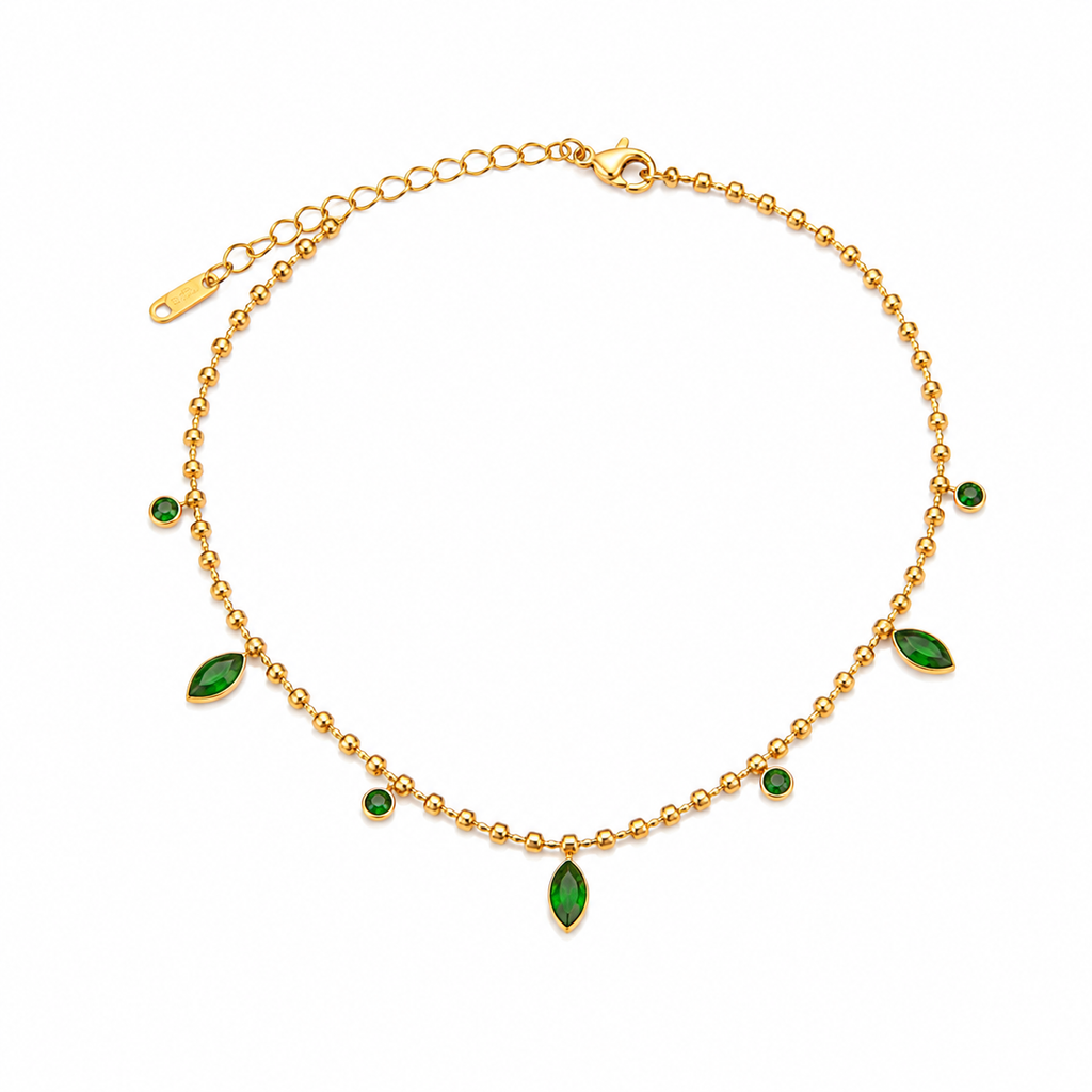 A gold ball-chain necklace with green marquise and round gemstone accents, displayed on a clean white background.