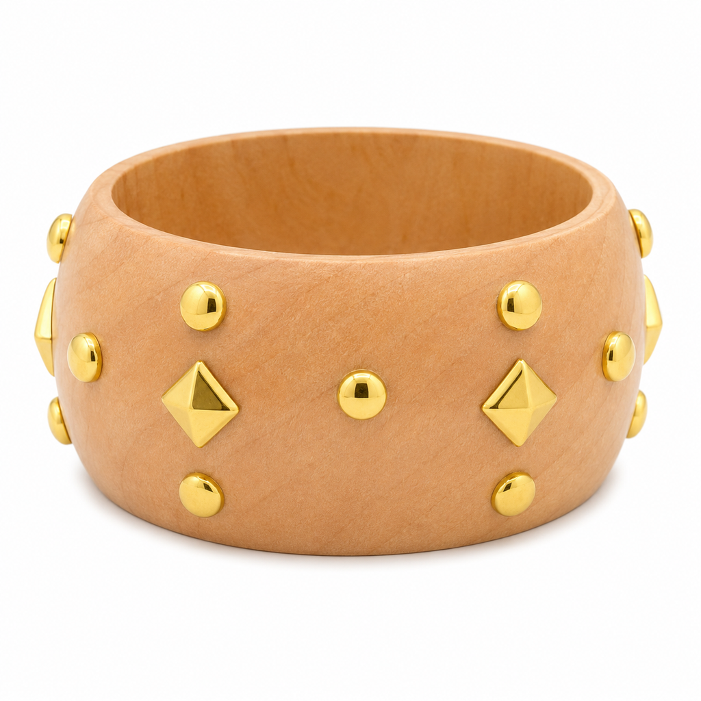 A wide tan leather cuff bracelet decorated with gold-tone metal studs and pyramid-shaped studs, shown on a plain white background.