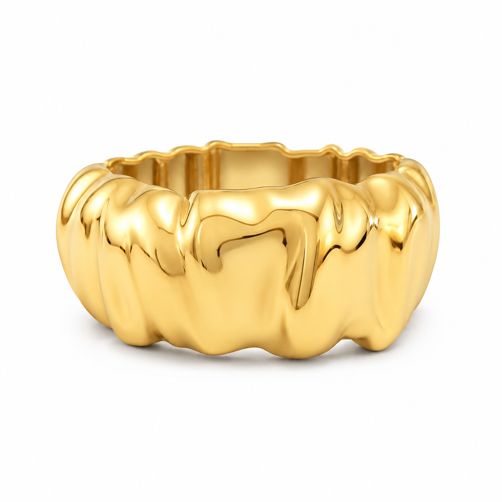 A polished yellow gold ring with a wavy, organic, fluid-like textured exterior, shown on a clean white background.