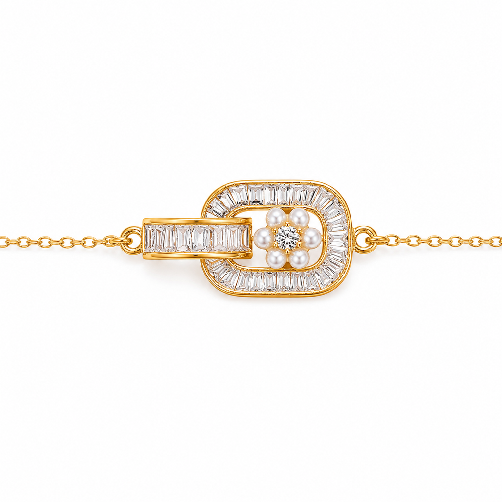 A gold chain bracelet featuring a central decorative knot-like pendant with a double oval frame set with clear baguette and round stones, and a small flower motif in the center with clear stones and white pearls, shown on a plain white background.