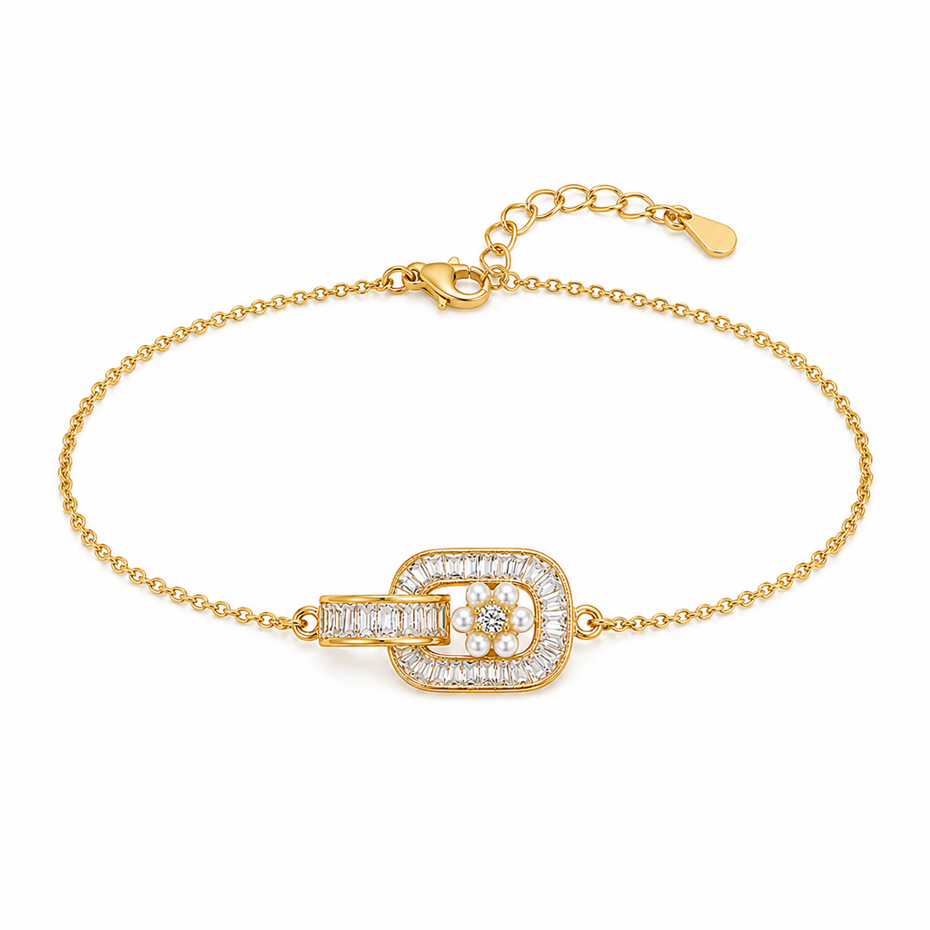 A gold chain bracelet with a central rectangular buckle-style charm paved with clear stones and a small flower motif in the center, shown on a plain white background.