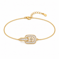 A gold chain bracelet with a central rectangular buckle-style charm paved with clear stones and a small flower motif in the center, shown on a plain white background.