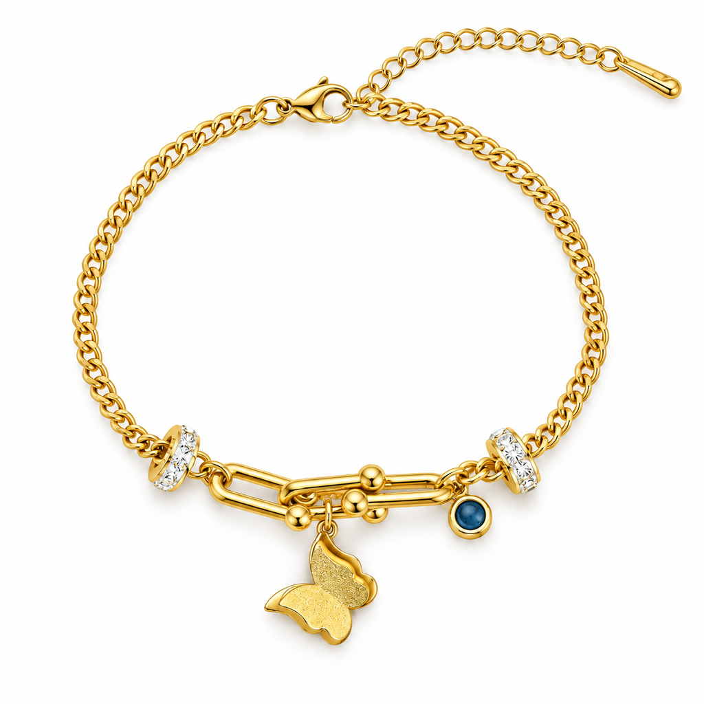 A gold chain bracelet with a butterfly charm, a small blue gemstone, and clear crystal accents, shown on a plain white background.