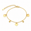 A gold chain anklet featuring three flat heart charms, two small round bead charms, and an adjustable lobster clasp with an extension chain, shown on a plain white background.