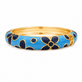 A gold-plated bangle bracelet featuring a vibrant blue enamel outer band decorated with dark navy blue floral motifs outlined in gold, shown against a plain white background.