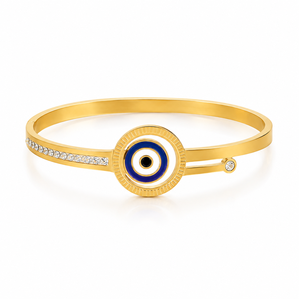 Gold bangle bracelet with a central evil eye motif in blue, white, and black, accented by a row of small clear stones on one side and a single stone on the other, shown on a white background.