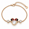 A rose gold chain bracelet featuring a Mickey Mouse-shaped charm with a white iridescent center, red and black crystals, and two clear crystal side stones, shown on a white background.