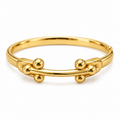 A polished gold-tone metal cuff bracelet with a central horizontal bar and four small raised bead-like spheres on each side, shown on a clean white background.