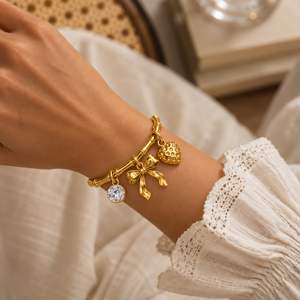 Elegant gold kada for women with bow pendant and textured heart charm