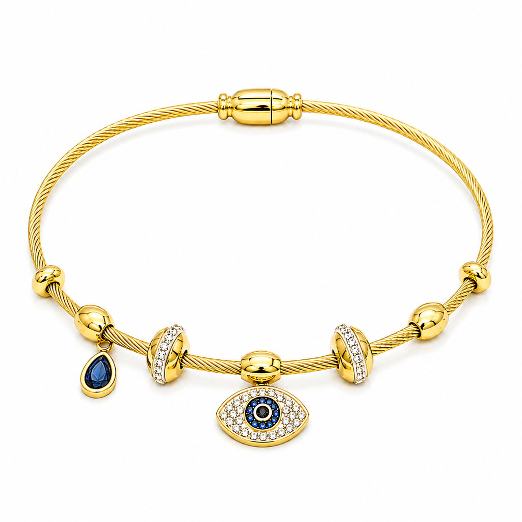 A gold cable bangle bracelet featuring a central evil eye charm with blue and white accents, a teardrop-shaped blue stone charm, and silver pavé bezel-set spacer beads, shown on a plain white background.