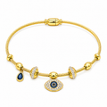A gold cable bangle bracelet featuring a central evil eye charm with blue and white accents, a teardrop-shaped blue stone charm, and silver pavé bezel-set spacer beads, shown on a plain white background.