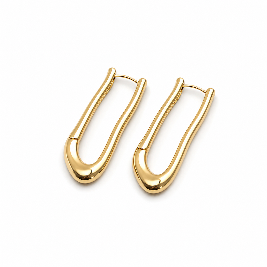 A pair of polished gold huggie hoop earrings with a smooth, rounded organic curve, displayed on a clean white background.