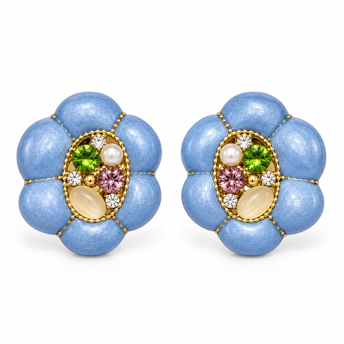 A pair of vintage-style flower-shaped stud earrings with textured light blue petals, gold-tone borders, and a central cluster of green, pink, white, and cream gemstones on a white background.