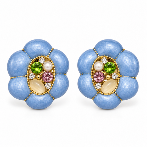 A pair of vintage-style flower-shaped stud earrings with textured light blue petals, gold-tone borders, and a central cluster of green, pink, white, and cream gemstones on a white background.