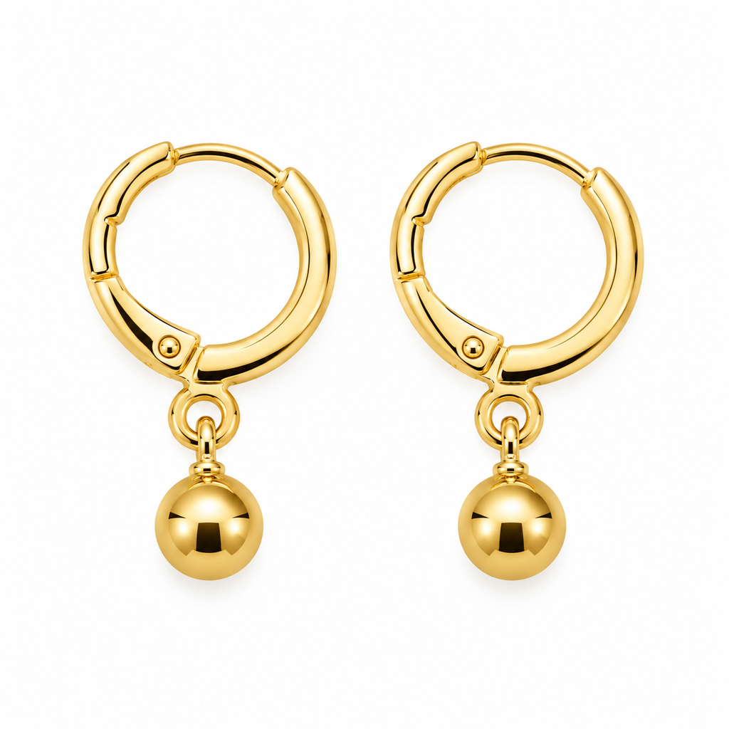 A pair of gold hoop earrings with a small dangling ball charm, shown on a plain white background.