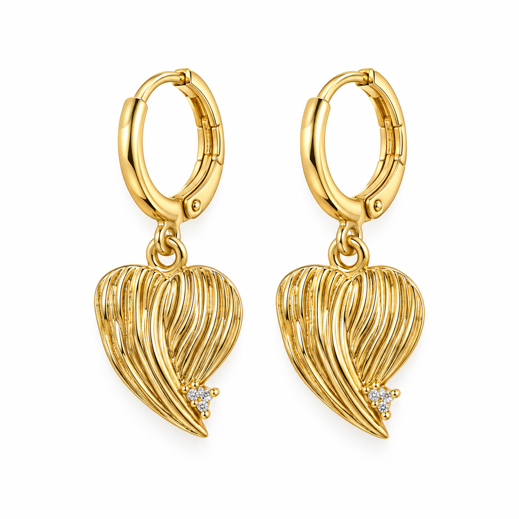 A pair of gold hoop earrings with dangling heart-shaped wire filigree pendants, each accented with a small clear gemstone, shown on a plain white background.