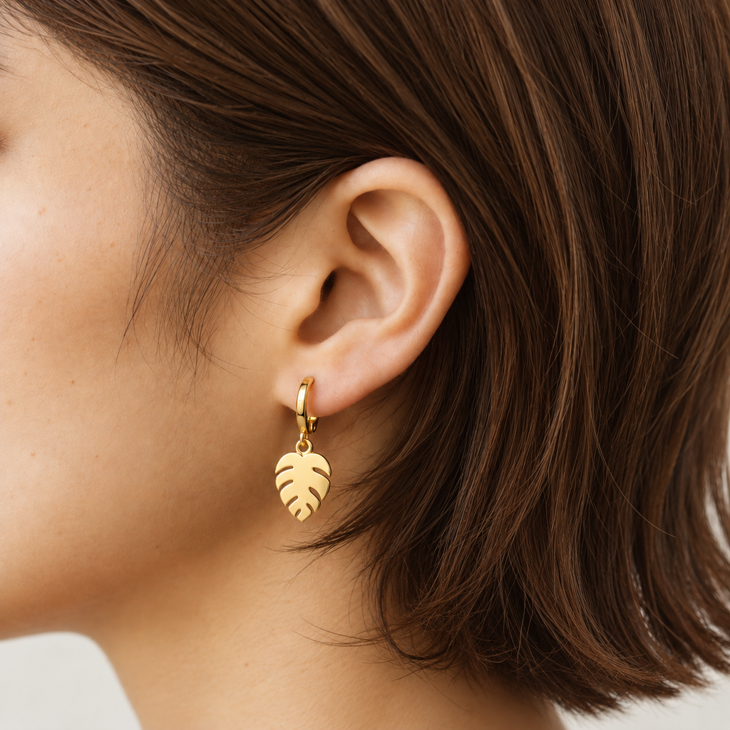 Gold leaf drop hoop earrings for women with tropical leaf design