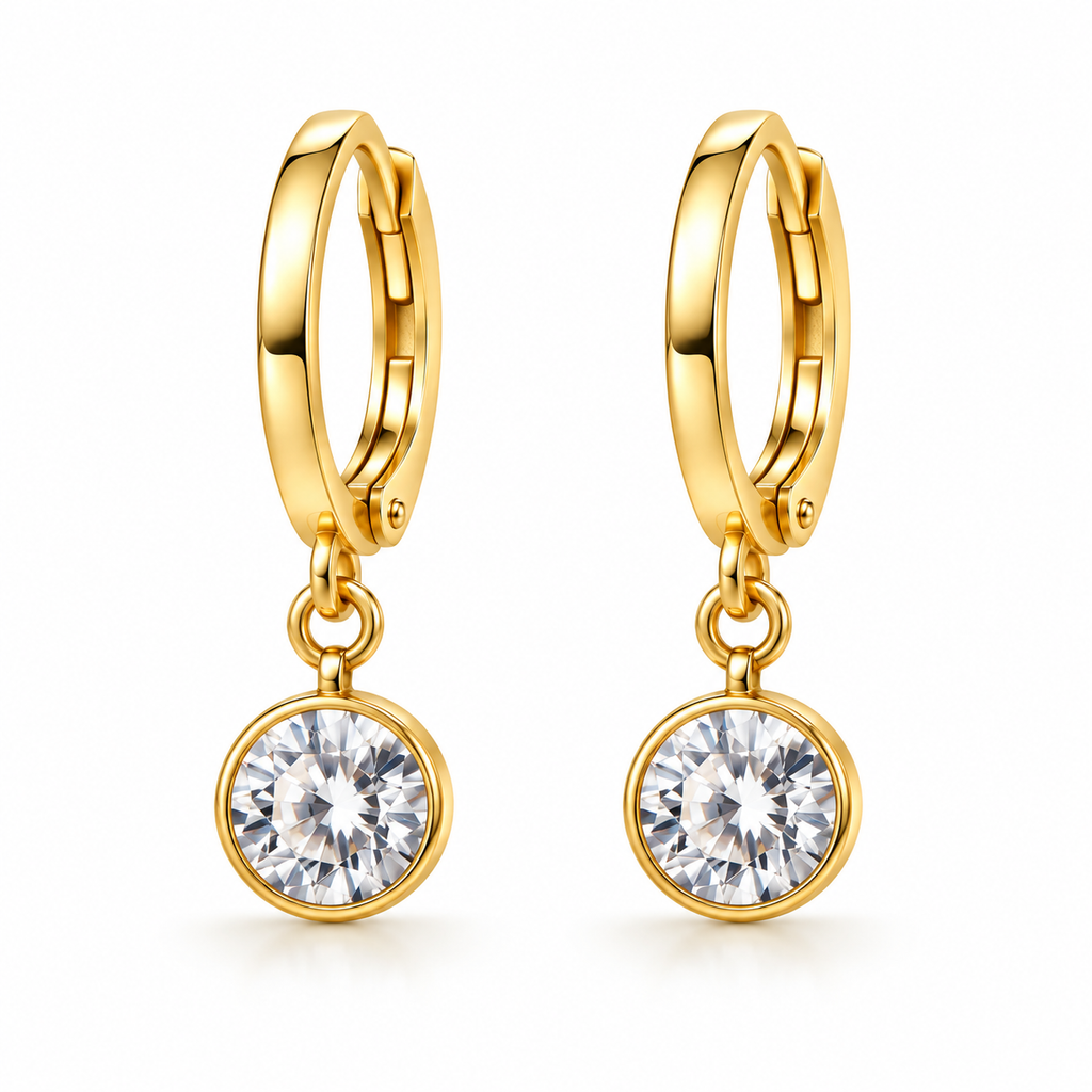 A pair of gold huggie hoop earrings with round bezel-set clear gemstones, shown on a clean white background.