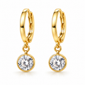 A pair of gold huggie hoop earrings with round bezel-set clear gemstones, shown on a clean white background.
