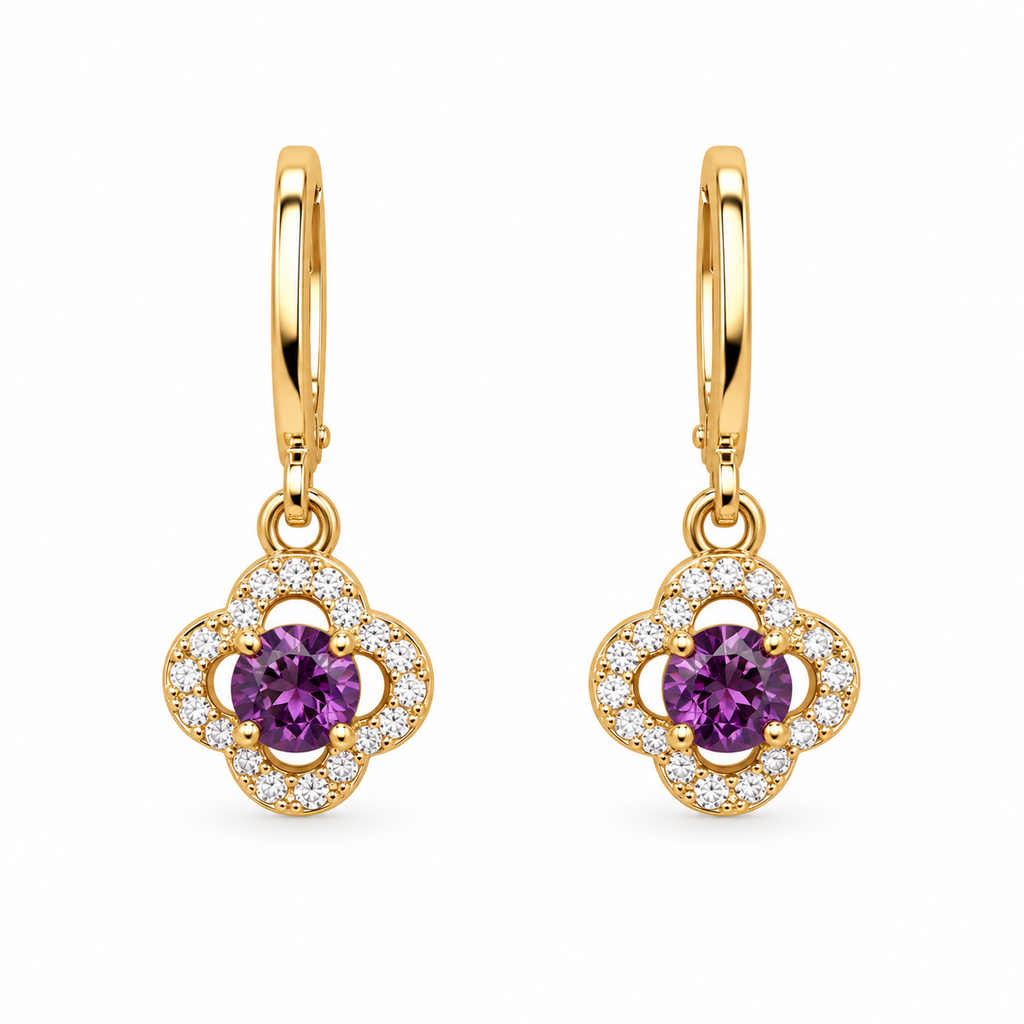 A pair of gold huggie hoop earrings with clover-shaped drops, featuring a central round purple gemstone surrounded by a halo of small clear stones, on a plain white background.