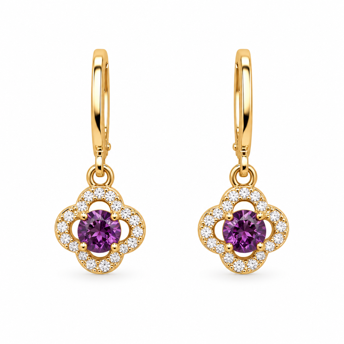 A pair of gold huggie hoop earrings with clover-shaped drops, featuring a central round purple gemstone surrounded by a halo of small clear stones, on a plain white background.