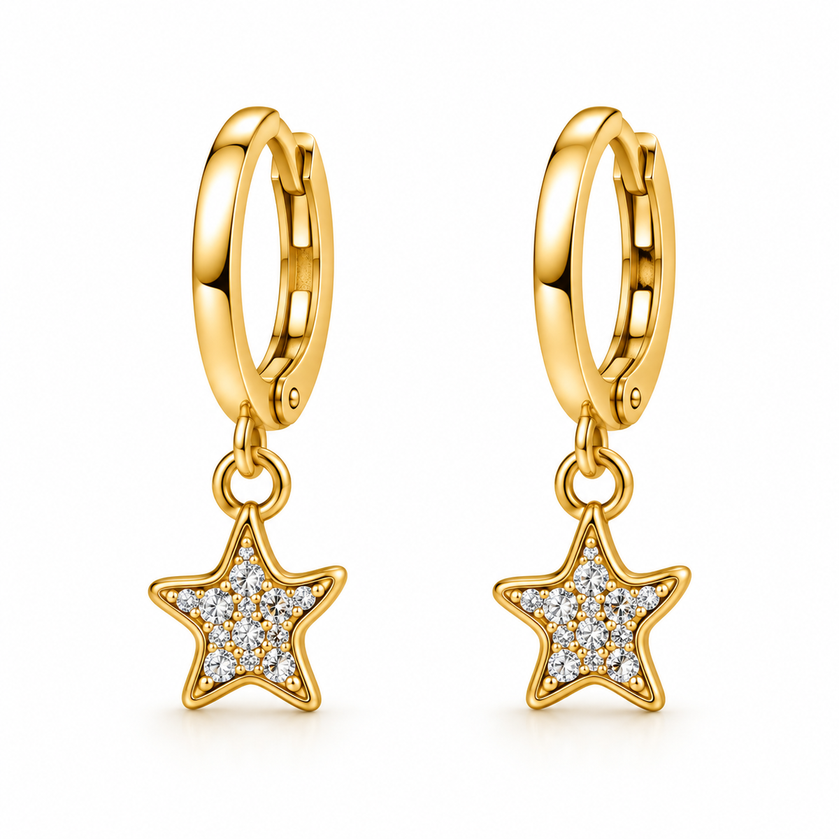 A pair of gold huggie hoop earrings with dangling star charms. One star charm is outlined in gold, while the other is paved with small clear stones, set against a clean white background.
