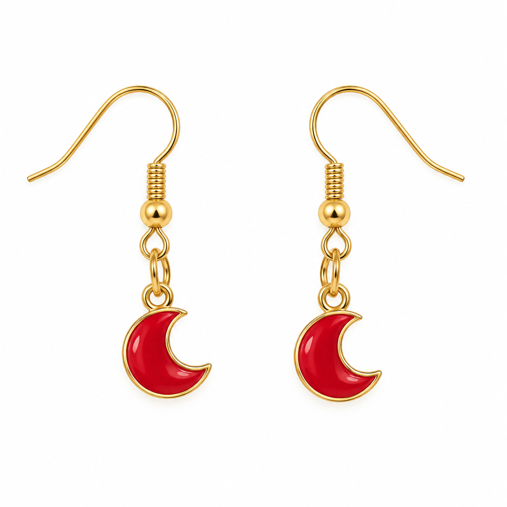 A pair of gold-tone dangle earrings with crescent moon charms filled with glossy red enamel, shown on a plain white background.