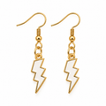 A pair of gold-tone lightning bolt drop earrings with white enamel fillings, shown on a plain white background.