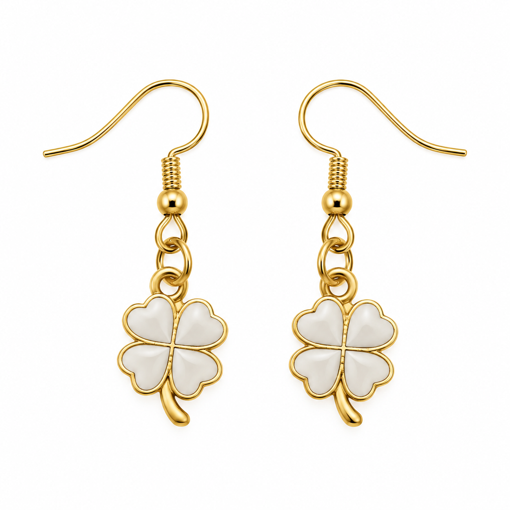 A pair of gold and white four-leaf clover dangle earrings on a solid white background.