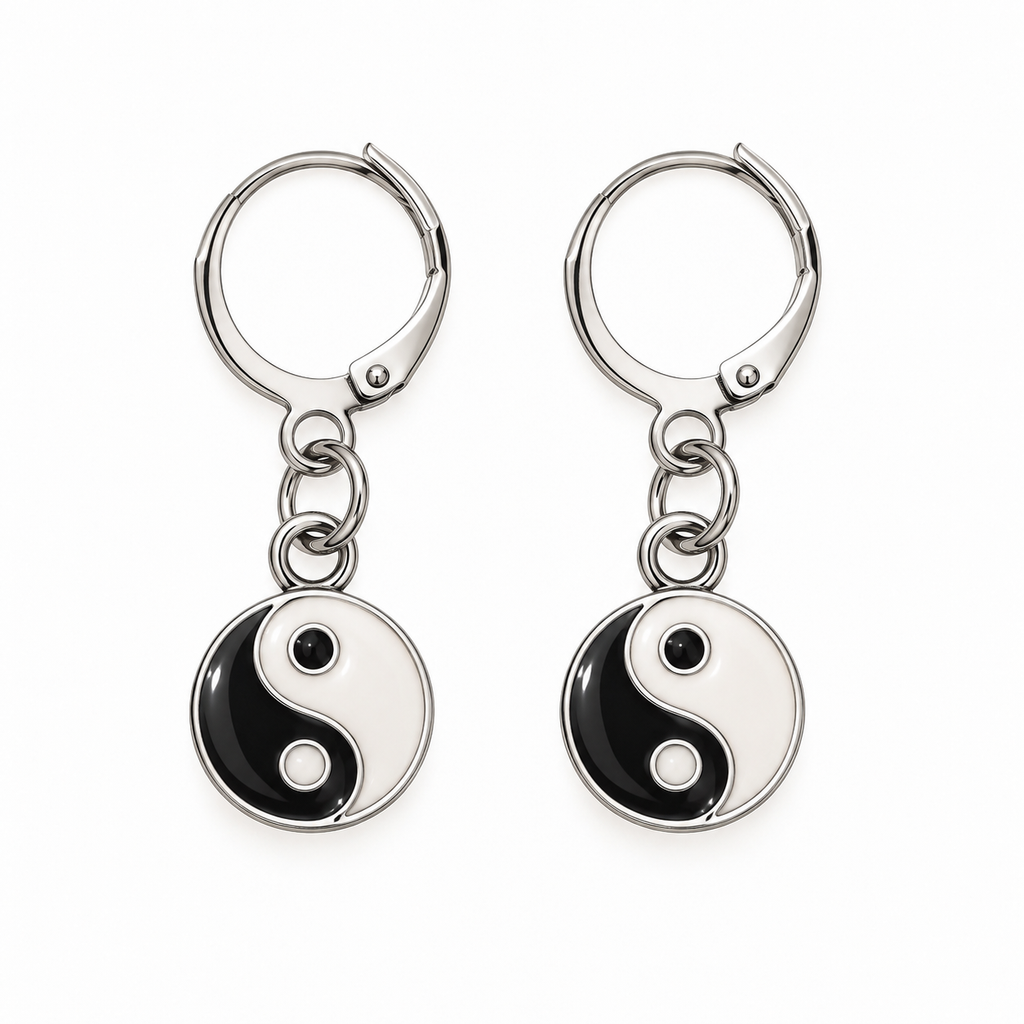 A pair of silver leverback earrings with round dangling charms featuring a black and white Yin Yang symbol, shown on a plain white background.