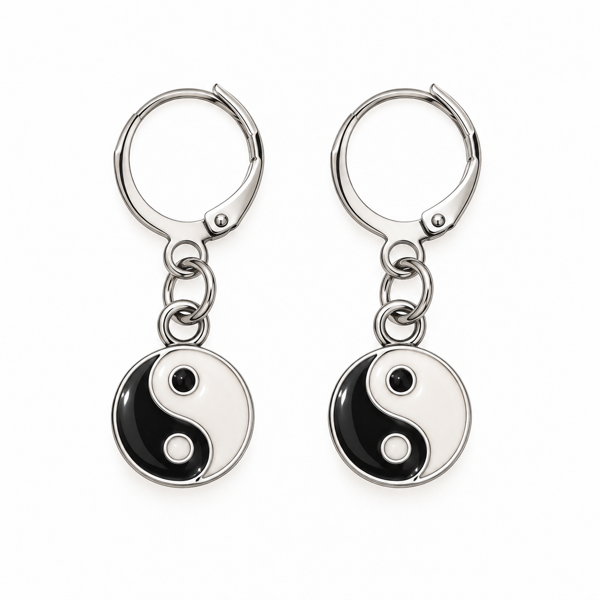 A pair of silver leverback earrings with round dangling charms featuring a black and white Yin Yang symbol, shown on a plain white background.