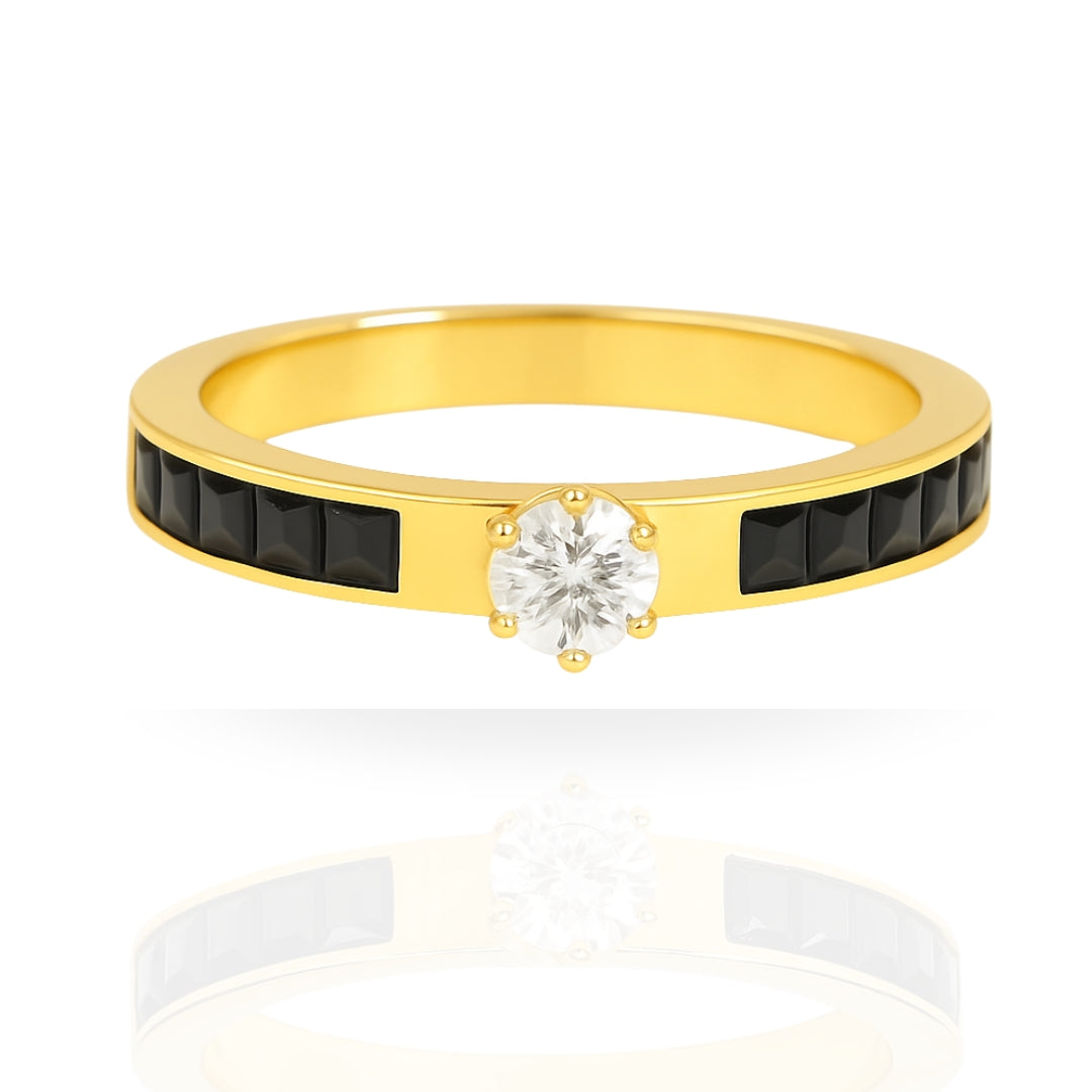 A yellow gold ring featuring a central round-cut clear gemstone in a prong setting, flanked by two rows of small black rectangular stones on the band, shown on a white background with a soft reflection.