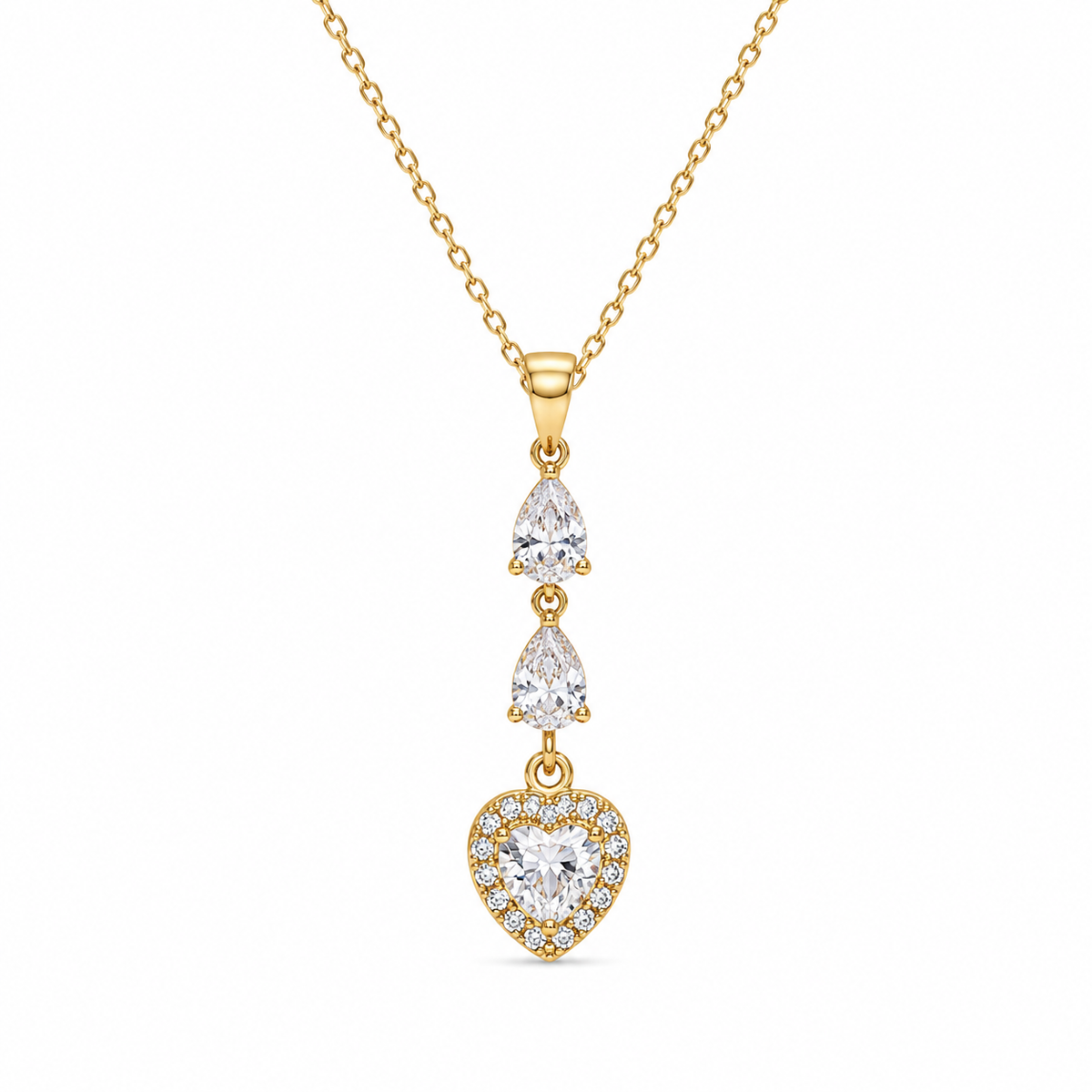 A gold dangle necklace featuring a heart-shaped pendant surrounded by small clear stones, with two pear-cut stones above on a delicate chain, set against a plain white background.