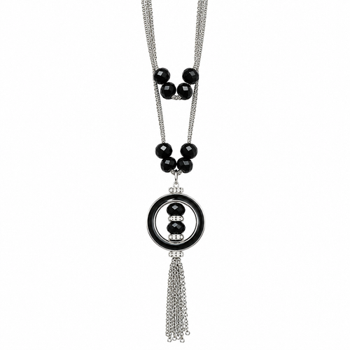 A silver-toned double-strand necklace featuring a central circular pendant with black enamel, black beads, and a dangling tassel, shown against a plain white background.