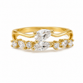 A yellow gold ring with marquise-cut clear gemstones, shown on a clean white background.