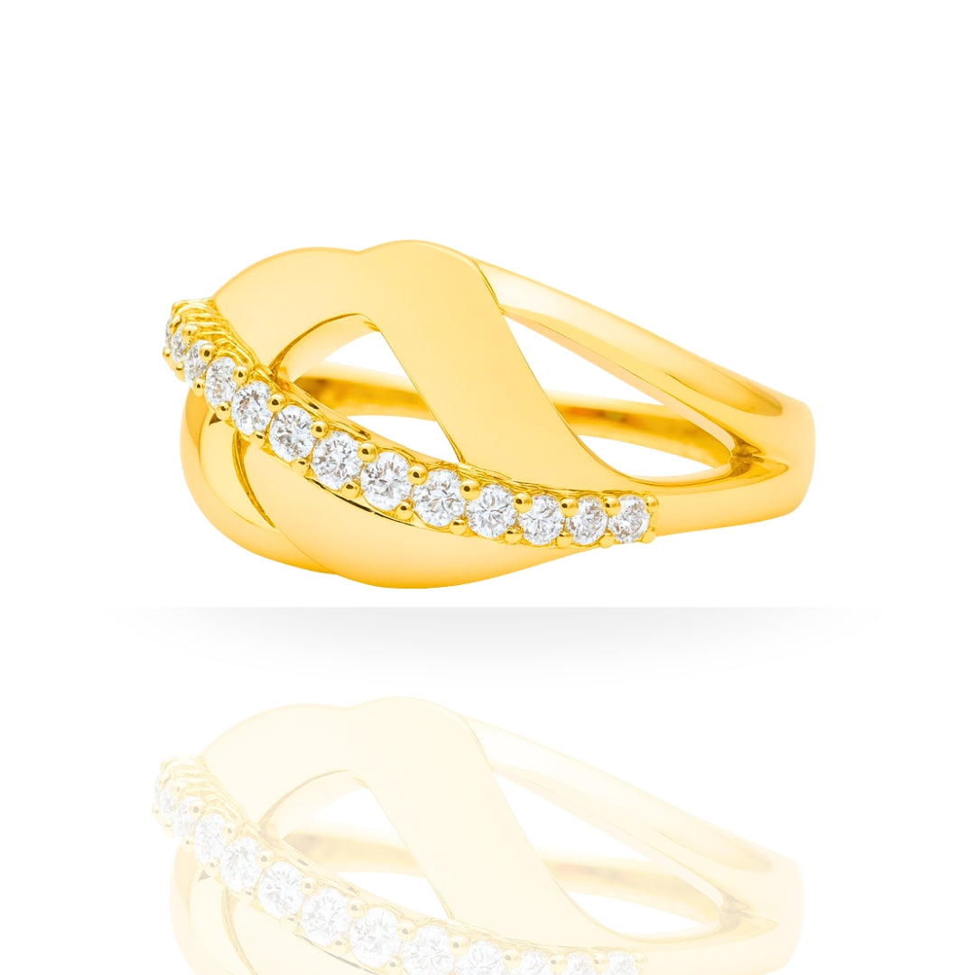 A yellow gold ring with an abstract, intertwined open design, featuring a row of clear round-cut gemstones along the front. The ring is displayed on a clean white background with a soft reflection below.